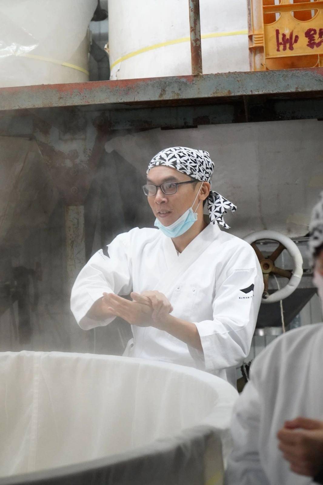 Hansel at the rice steamer at Kitsukura brewery, Nagano